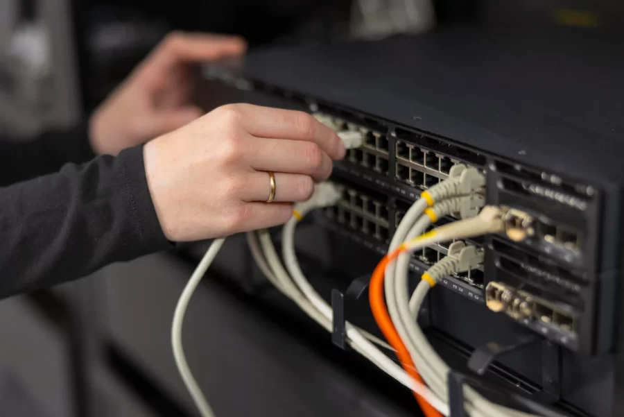 female-it-technician-in-a-datacenter-connecting-an-2025-11-13-23-03-37-utc